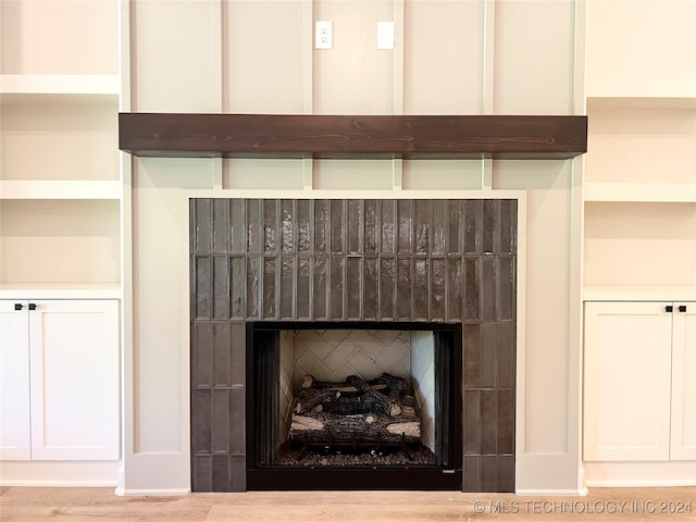 room details featuring a fireplace and custom exhaust hood