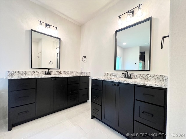 full bathroom with two vanities, a sink, and tile patterned floors