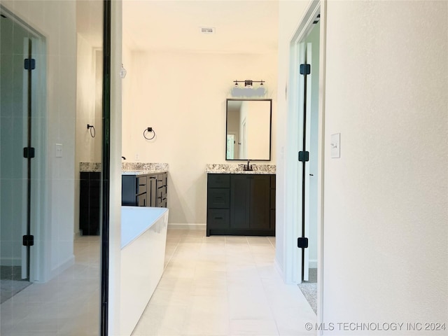 corridor featuring baseboards, visible vents, and a sink