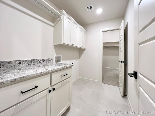 laundry area with recessed lighting, washer hookup, visible vents, baseboards, and cabinet space