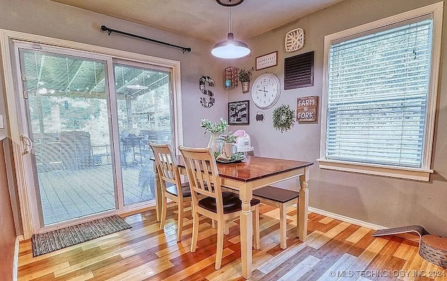 dining space with plenty of natural light and light wood-type flooring