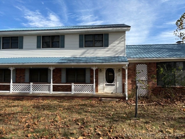 view of front of home with a front yard and covered porch