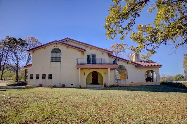 view of front of property with a balcony and a front yard