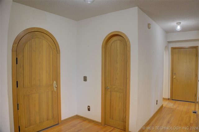 17808 S 129th E Ave, Bixby, OK 74008 - entrance foyer featuring arched walkways, light wood finished floors, a textured ceiling, and baseboards