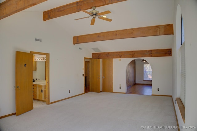 17808 S 129th E Ave, Bixby, OK 74008 - empty room featuring arched walkways, beamed ceiling, light carpet, ceiling fan, and baseboards