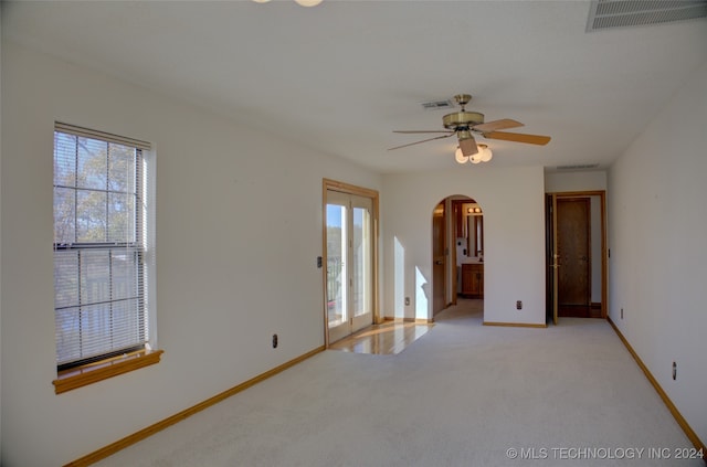 carpeted empty room featuring ceiling fan