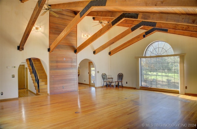 17808 S 129th E Ave, Bixby, OK 74008 - unfurnished living room with arched walkways, a ceiling fan, high vaulted ceiling, beam ceiling, and plenty of natural light