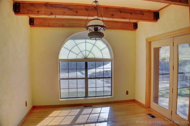 interior space featuring beam ceiling and hardwood / wood-style flooring