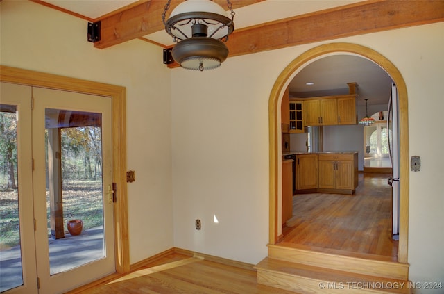 interior space with beamed ceiling and light hardwood / wood-style flooring