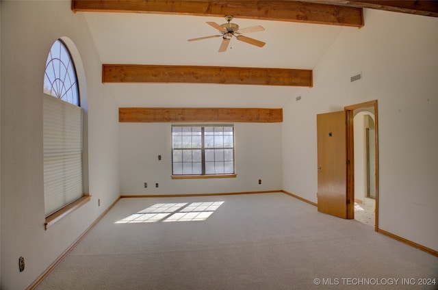 spare room featuring beam ceiling, ceiling fan, high vaulted ceiling, and light colored carpet