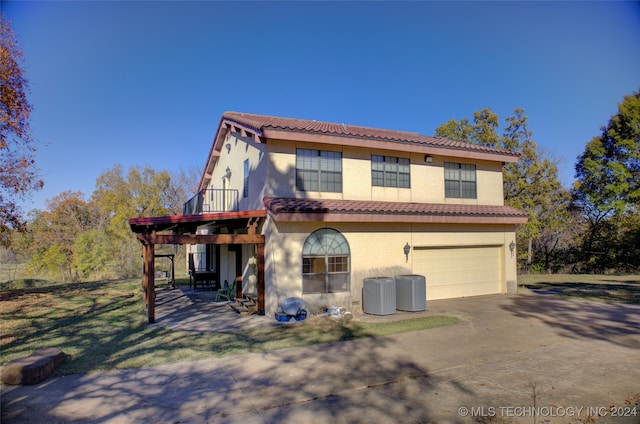 mediterranean / spanish house with central AC and a garage