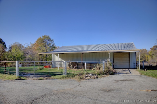 17808 S 129th E Ave, Bixby, OK 74008 - view of front facade featuring an exterior structure, an outbuilding, metal roof, and board and batten siding
