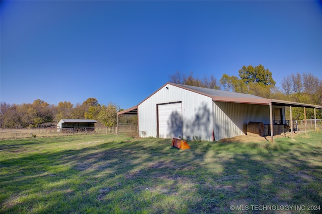 view of outdoor structure with a garage and a yard