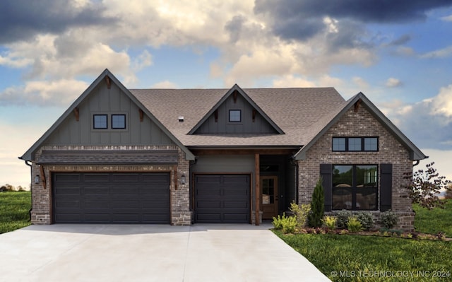 craftsman-style home featuring a front yard and a garage