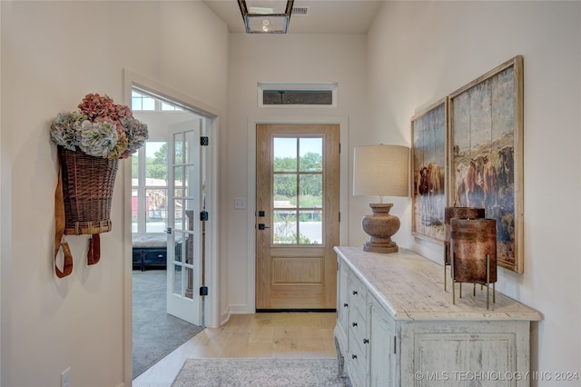 entryway featuring light carpet