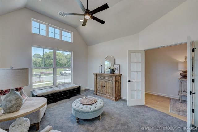 living area with ceiling fan, hardwood / wood-style floors, high vaulted ceiling, and french doors