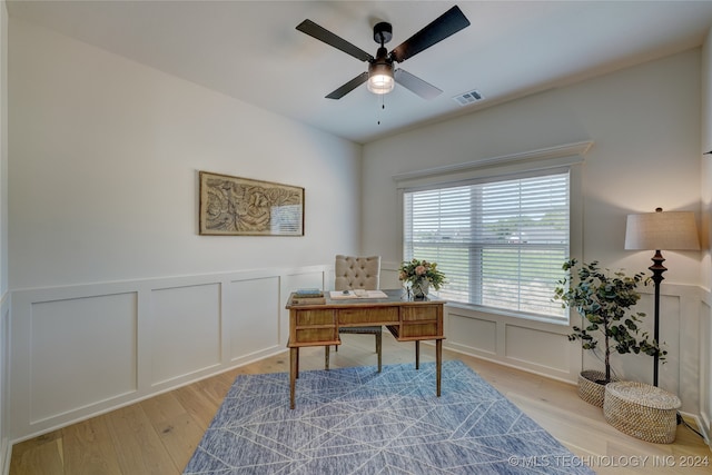 office with ceiling fan and light hardwood / wood-style flooring