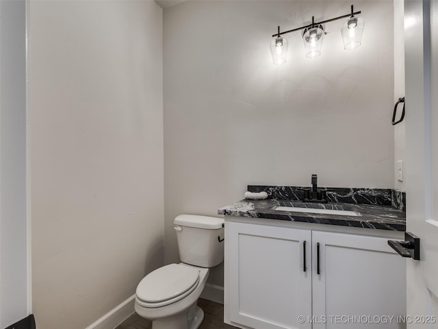 bathroom featuring toilet and vanity