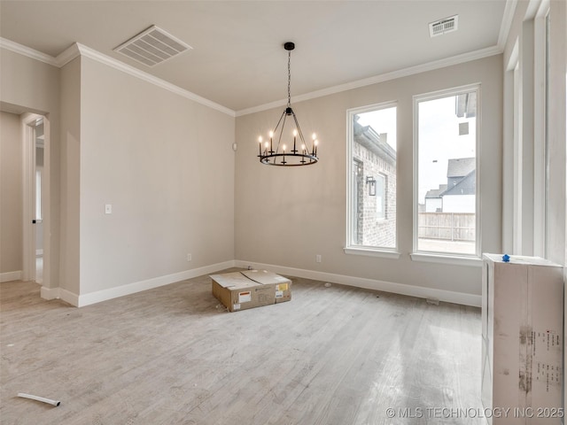 spare room with crown molding, a notable chandelier, and a healthy amount of sunlight