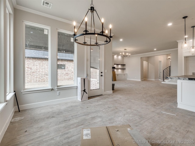 unfurnished dining area with crown molding and an inviting chandelier