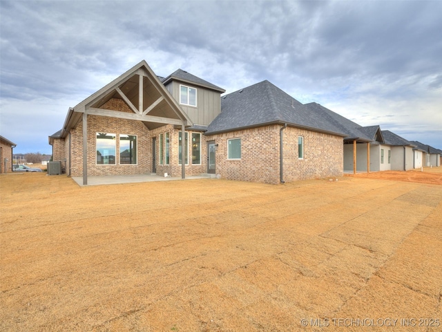 back of property featuring central AC and a patio area