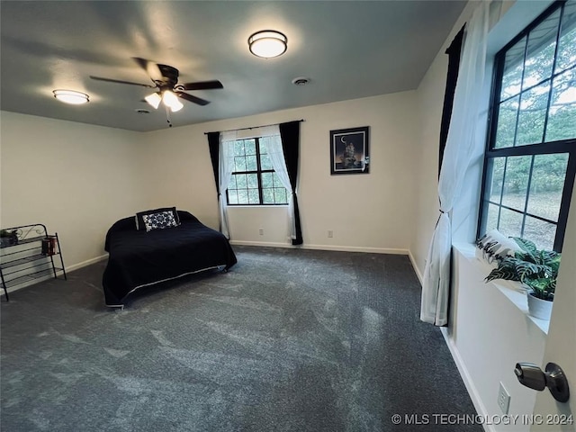 bedroom with dark colored carpet and ceiling fan