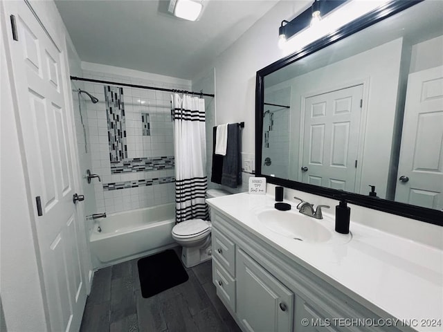 full bathroom with hardwood / wood-style flooring, vanity, toilet, and shower / bathtub combination with curtain