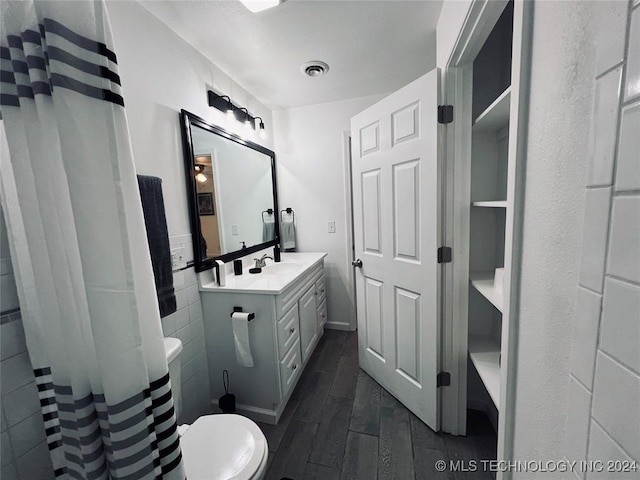 bathroom featuring hardwood / wood-style floors, vanity, and toilet