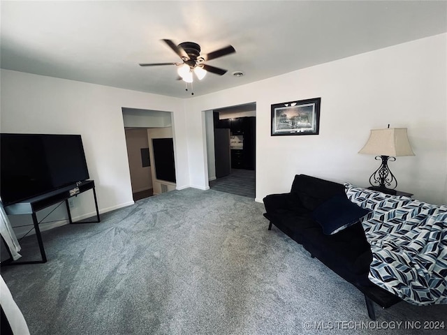 carpeted living room with ceiling fan