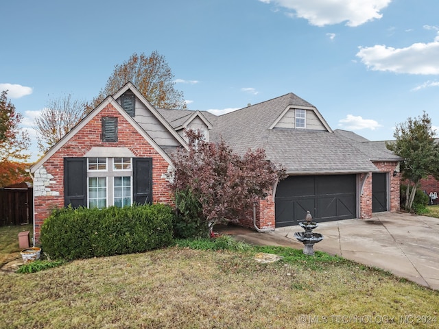 view of front facade with a garage and a front lawn