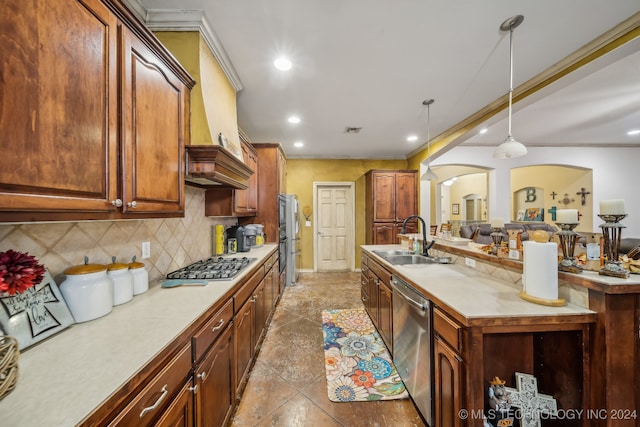 kitchen featuring sink, tile patterned flooring, an island with sink, appliances with stainless steel finishes, and decorative light fixtures