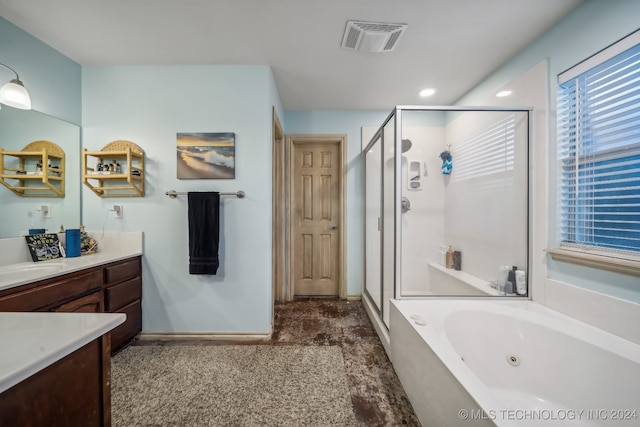 bathroom with vanity and independent shower and bath