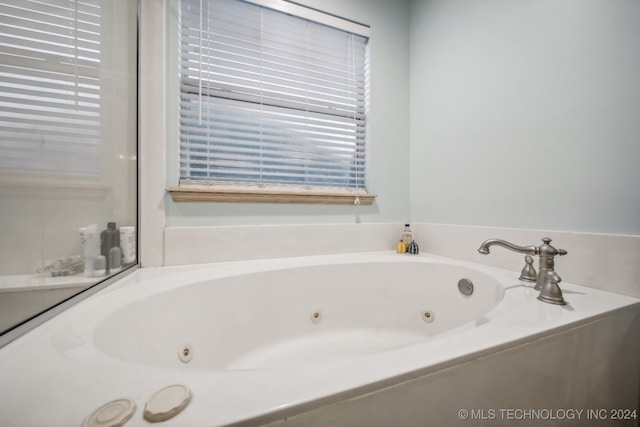 bathroom with a tub to relax in