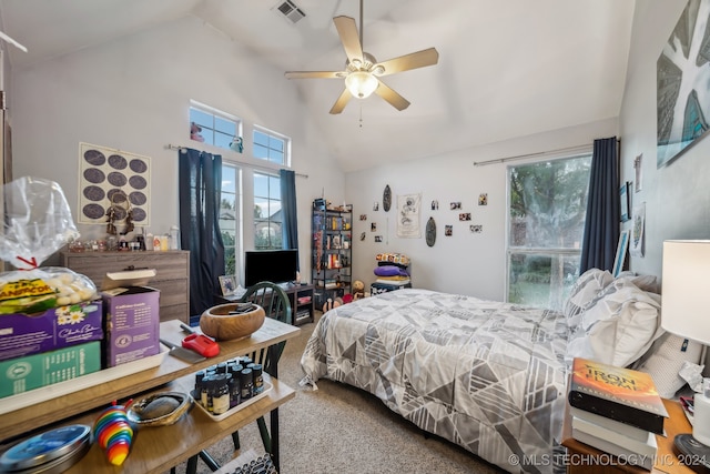 carpeted bedroom with ceiling fan and vaulted ceiling