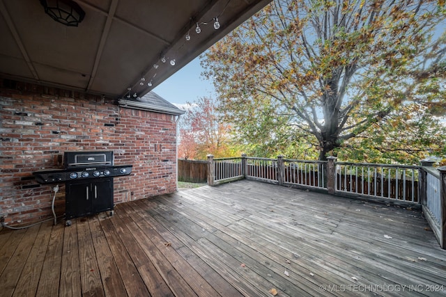 wooden terrace featuring area for grilling