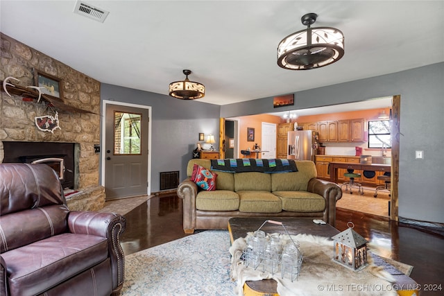 living room with wood-type flooring and a fireplace