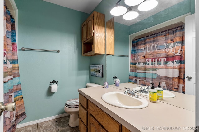 bathroom featuring vanity, tile patterned floors, and toilet