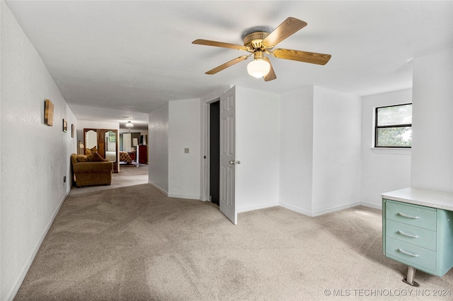 unfurnished room featuring light colored carpet and ceiling fan