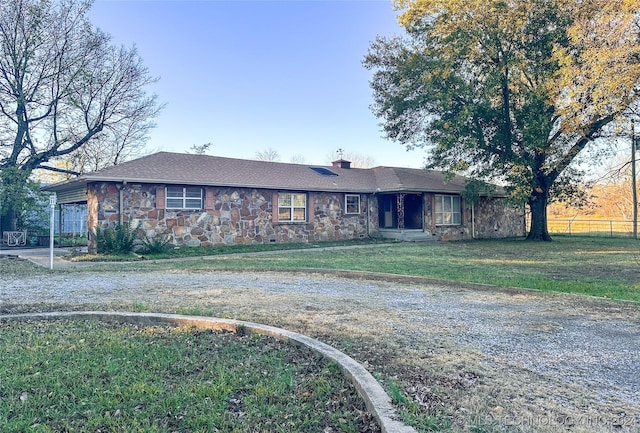 ranch-style home featuring a front yard