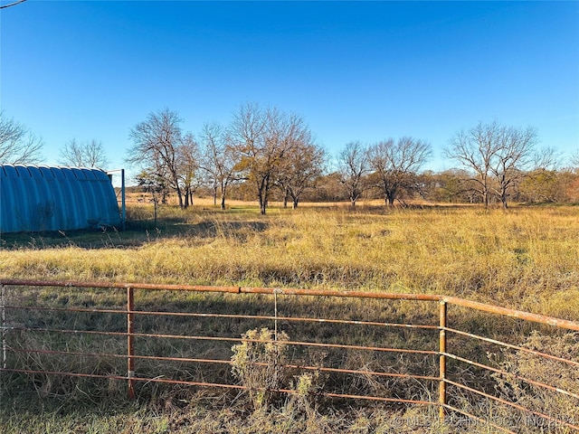 view of yard with a rural view