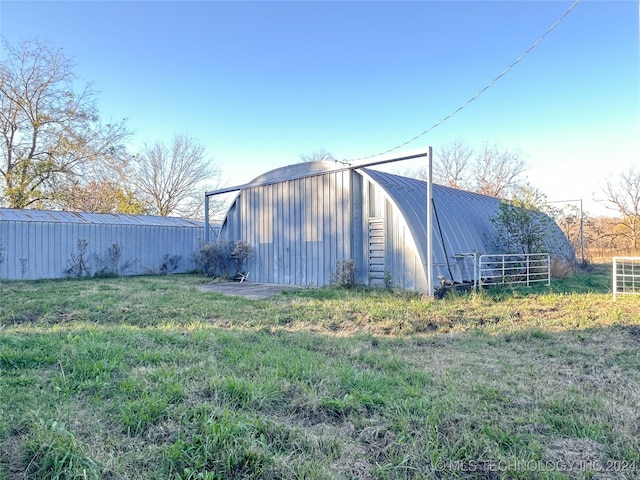 view of outbuilding featuring a yard