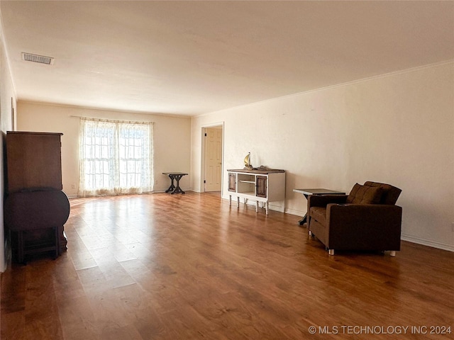 sitting room featuring crown molding and hardwood / wood-style flooring