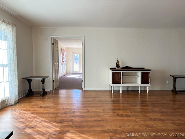 empty room featuring crown molding and dark hardwood / wood-style floors