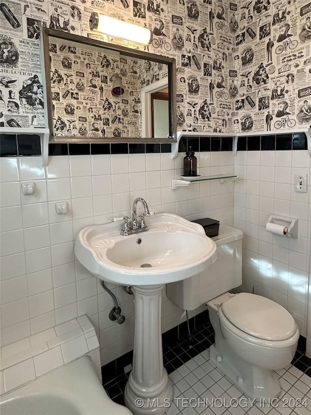 bathroom featuring toilet, tile walls, and tile patterned floors