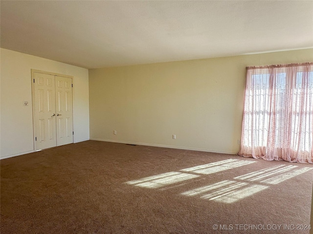 unfurnished room with carpet floors