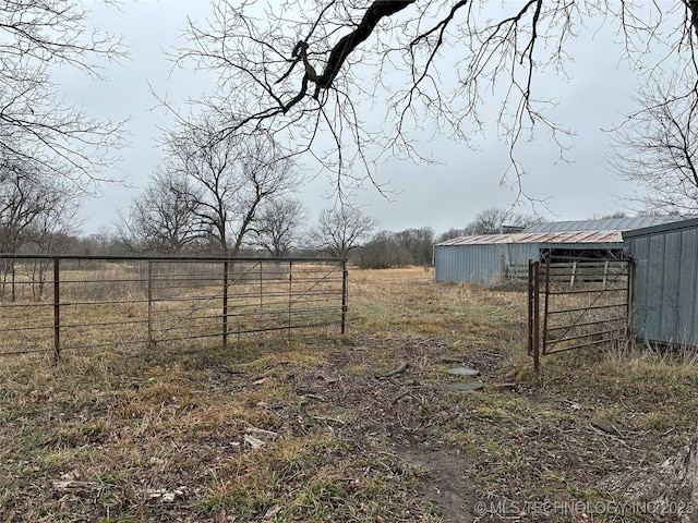 view of yard featuring an outbuilding and a rural view