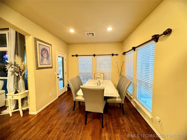 dining space with plenty of natural light and dark wood-type flooring