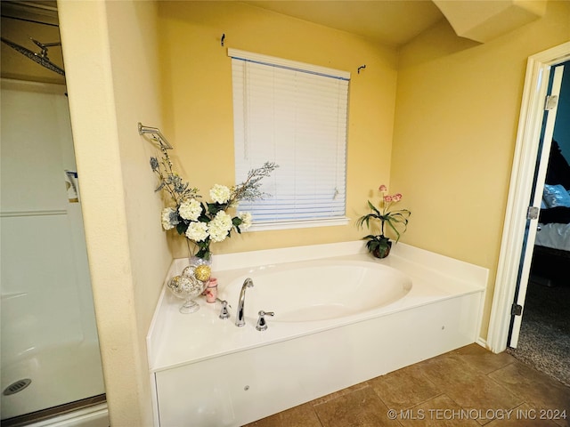 bathroom featuring tile patterned flooring and a bathing tub