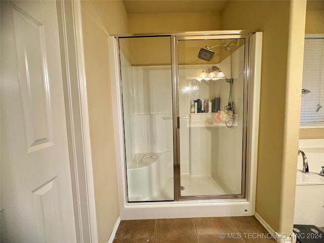 bathroom with tile patterned flooring and an enclosed shower