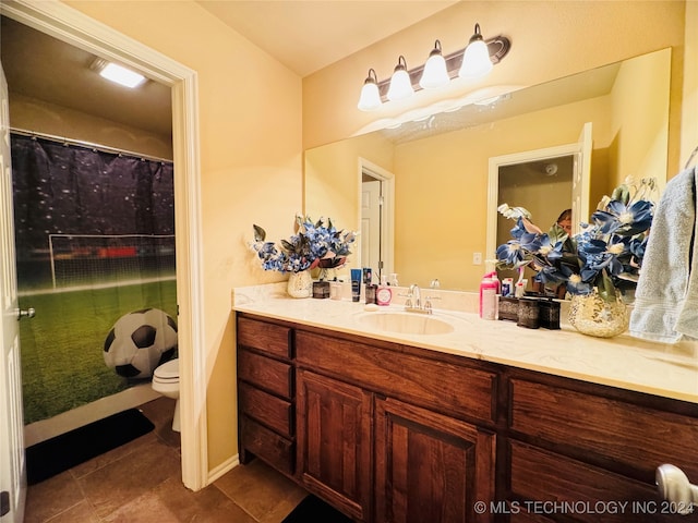 bathroom with tile patterned floors, vanity, and toilet